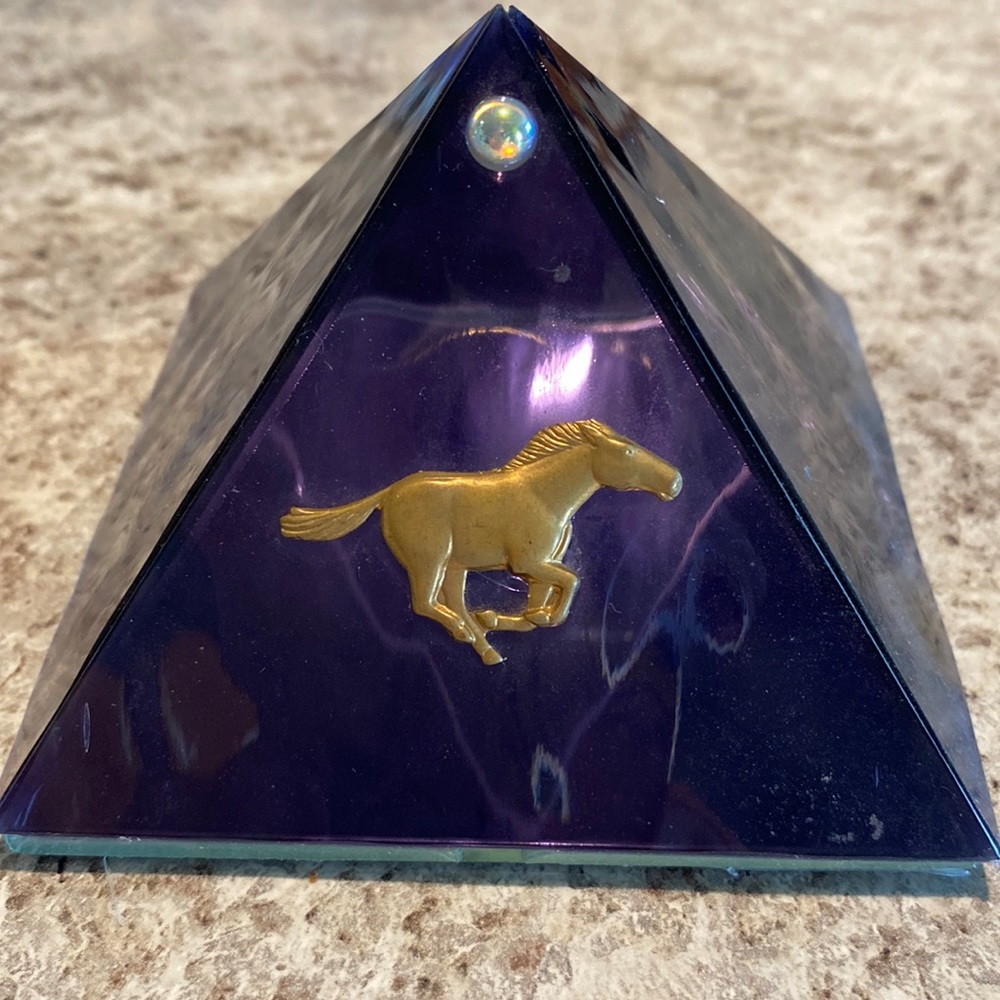 Purple Glass Pyramid with a horse on the front.